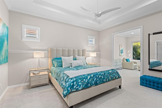 bedroom featuring carpet flooring, ceiling fan, a tray ceiling, and crown molding