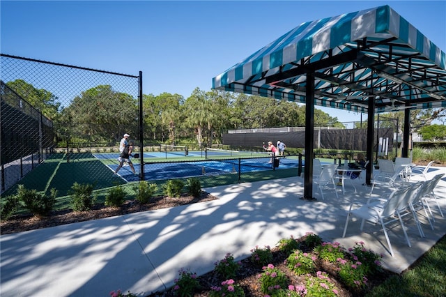 view of property's community with tennis court