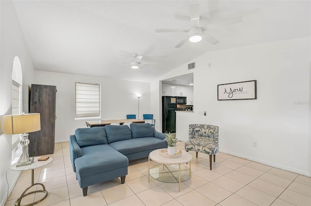 tiled living room with ceiling fan and lofted ceiling