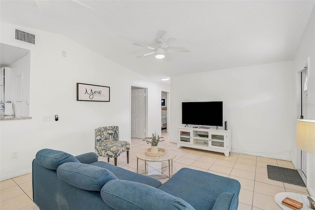 tiled living room featuring ceiling fan and lofted ceiling