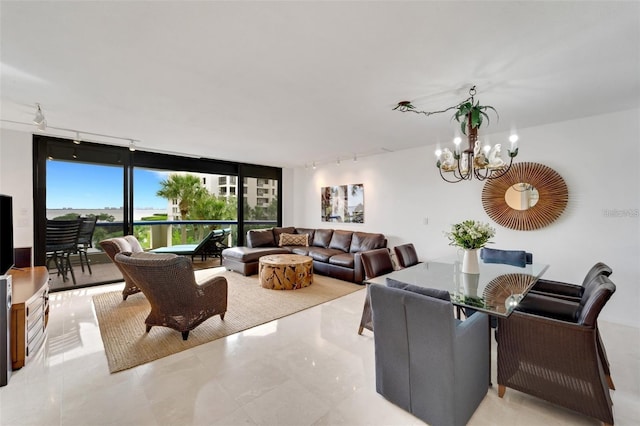 living room with a notable chandelier, floor to ceiling windows, and track lighting