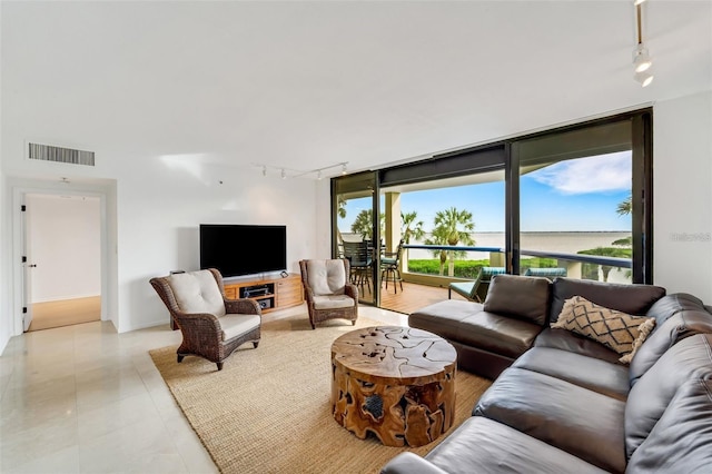 living room featuring expansive windows and track lighting