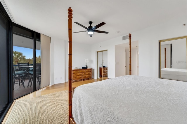 bedroom with access to exterior, ceiling fan, hardwood / wood-style floors, and floor to ceiling windows