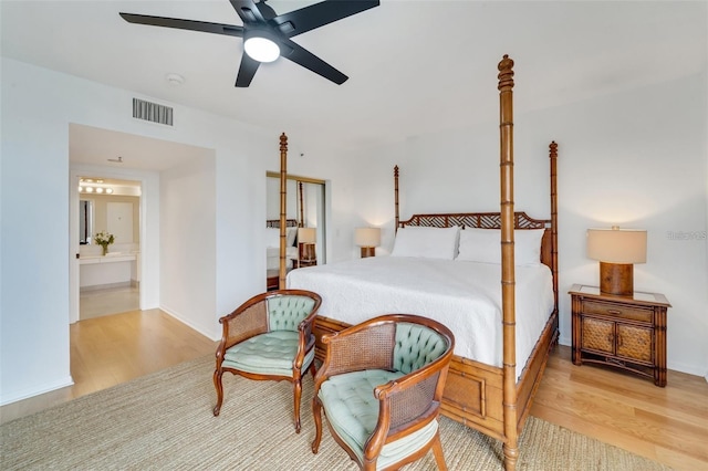 bedroom featuring light wood-type flooring, connected bathroom, and ceiling fan