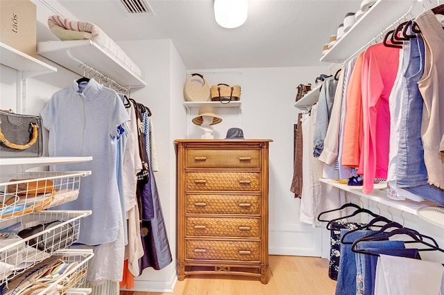 walk in closet featuring light hardwood / wood-style flooring