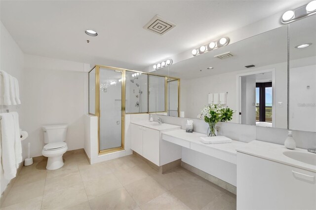 bathroom featuring vanity, toilet, and walk in shower