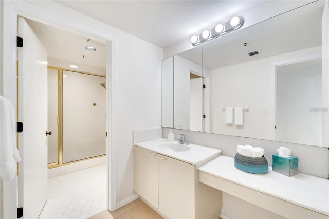 bathroom with vanity, tile patterned floors, and a shower with door