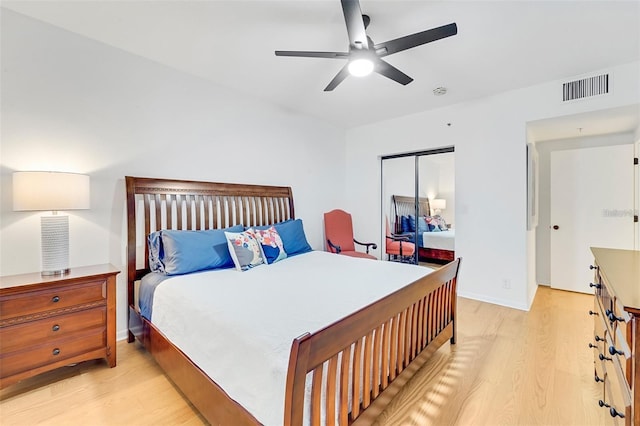 bedroom with a closet, ceiling fan, and light hardwood / wood-style flooring