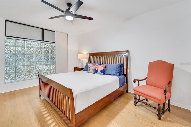 bedroom with ceiling fan and light hardwood / wood-style floors