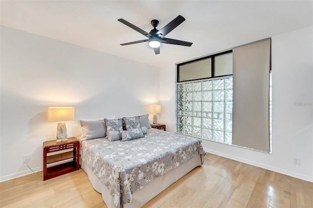 bedroom with ceiling fan and hardwood / wood-style flooring