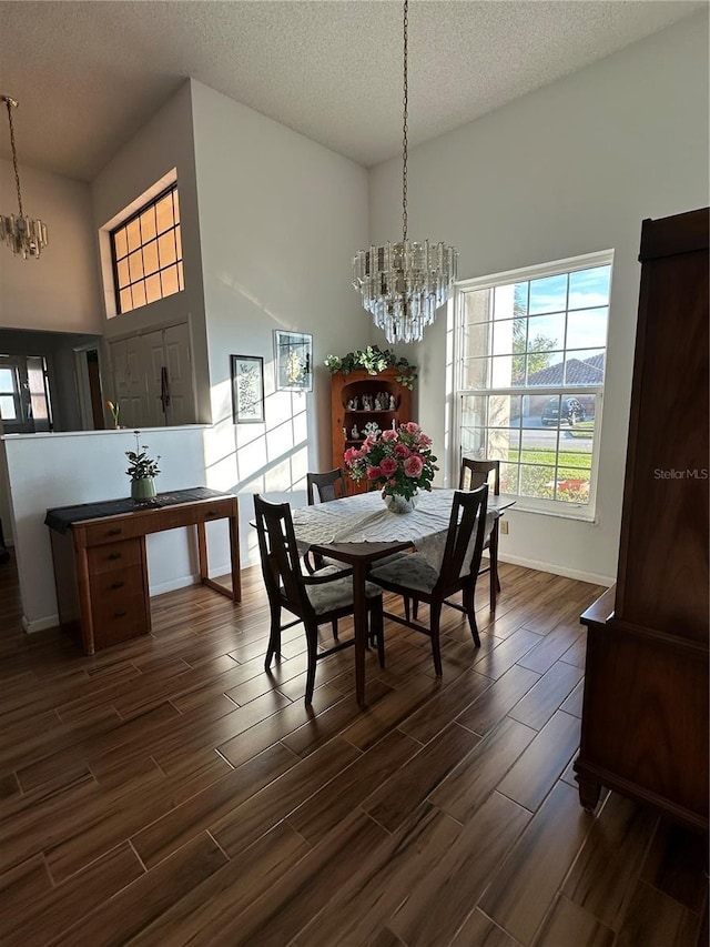 dining area featuring a textured ceiling and a chandelier