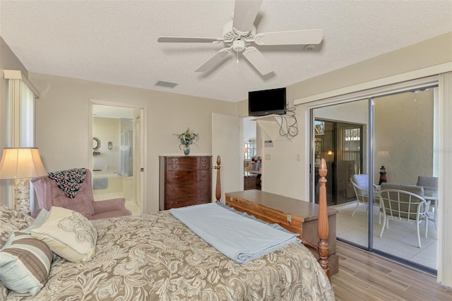 bedroom with ensuite bathroom, access to exterior, ceiling fan, a textured ceiling, and light hardwood / wood-style flooring