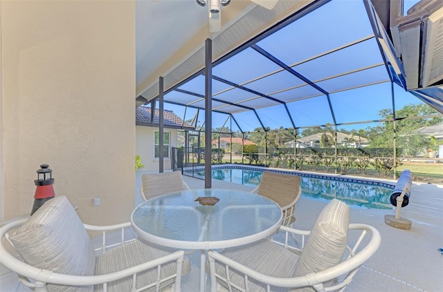 view of patio featuring glass enclosure