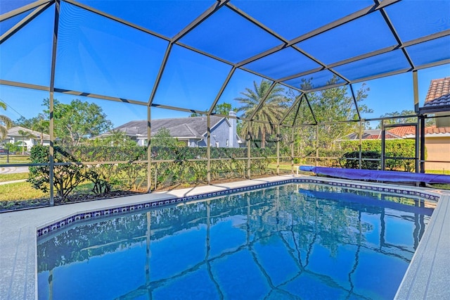 view of pool featuring glass enclosure and a patio area