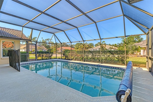 view of swimming pool featuring glass enclosure