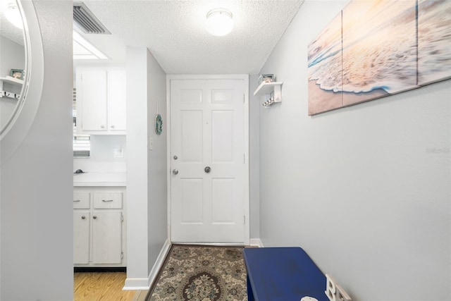 bathroom with vanity and a textured ceiling