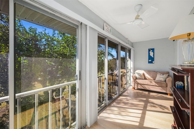 sunroom / solarium featuring ceiling fan