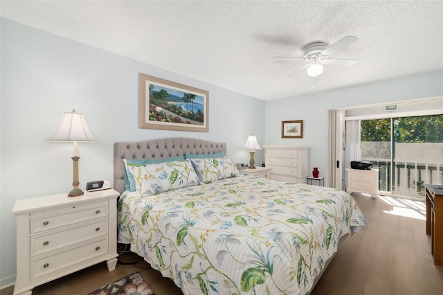 bedroom featuring ceiling fan, a textured ceiling, access to outside, and dark wood-type flooring