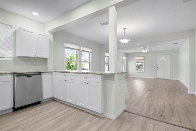 kitchen featuring light wood-style flooring, white cabinetry, baseboards, open floor plan, and dishwasher