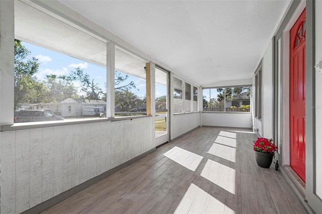 unfurnished sunroom with vaulted ceiling