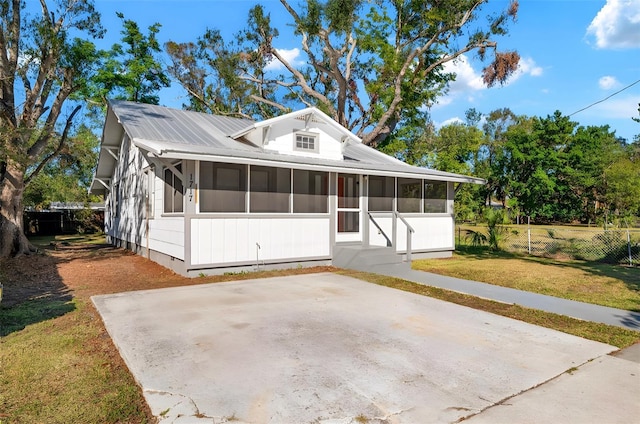 view of front of home featuring crawl space, a sunroom, fence, and a front yard