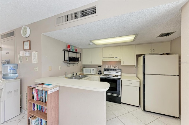 kitchen with kitchen peninsula, white appliances, sink, and light tile patterned flooring