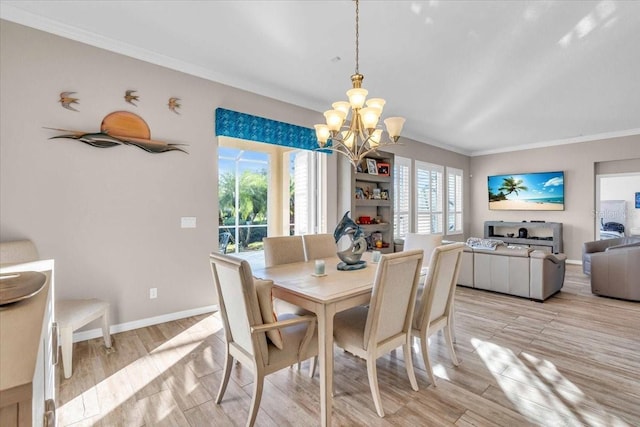 dining space with a notable chandelier, light hardwood / wood-style flooring, crown molding, and a wealth of natural light