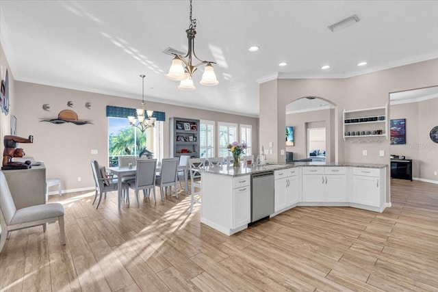 kitchen featuring white cabinetry, kitchen peninsula, stainless steel dishwasher, a chandelier, and pendant lighting