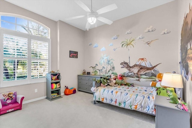 bedroom featuring multiple windows, ceiling fan, and carpet