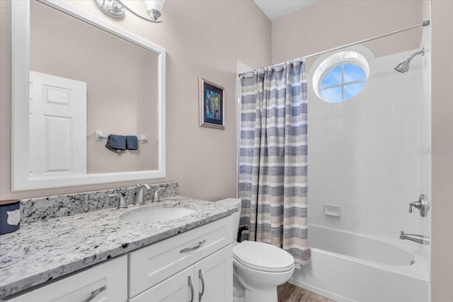 full bathroom with toilet, vanity, hardwood / wood-style floors, and shower / bath combo with shower curtain