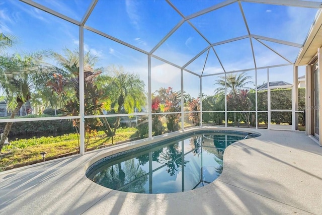 view of swimming pool featuring a lanai and a patio