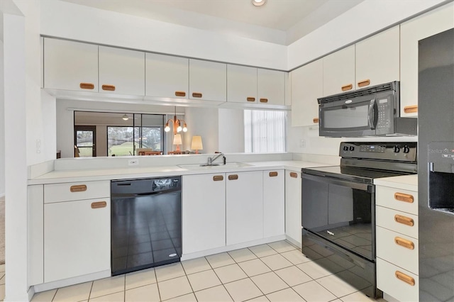 kitchen with sink, white cabinets, and black appliances