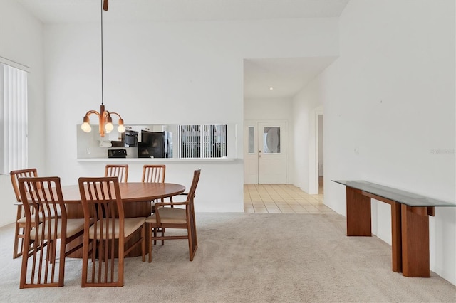 dining room featuring light colored carpet and a notable chandelier