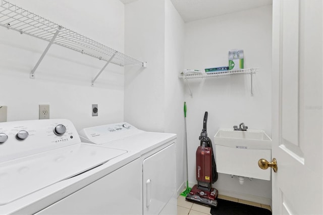 laundry room with sink, light tile patterned floors, and washing machine and clothes dryer