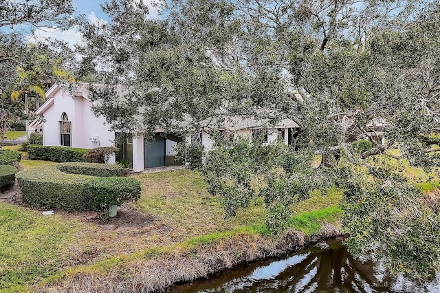 view of front of house with a water view