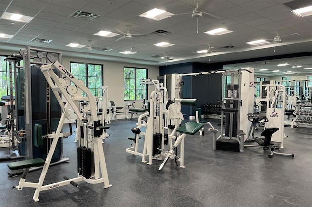 gym featuring a drop ceiling and ceiling fan