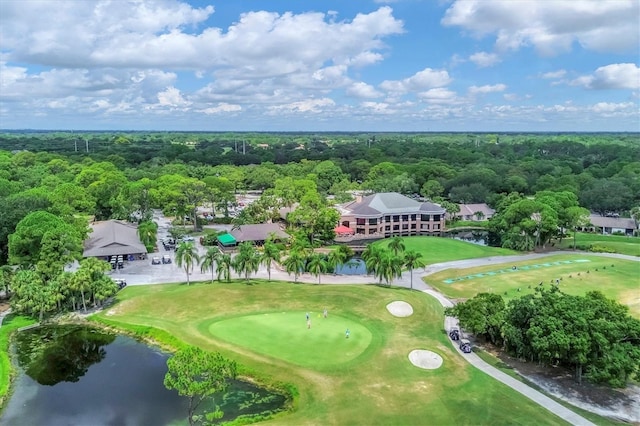 bird's eye view featuring a water view, a view of trees, and view of golf course