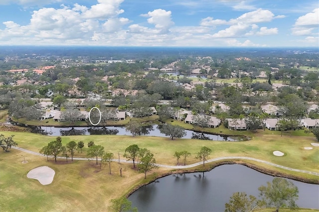 drone / aerial view featuring golf course view and a water view