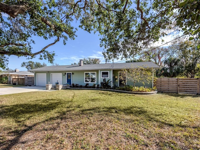 single story home featuring a front yard and a garage