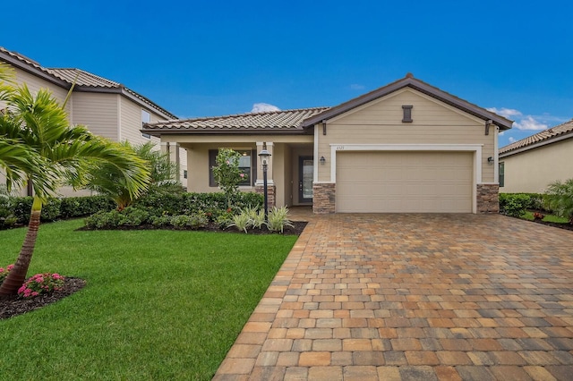 view of front of property with a garage and a front lawn