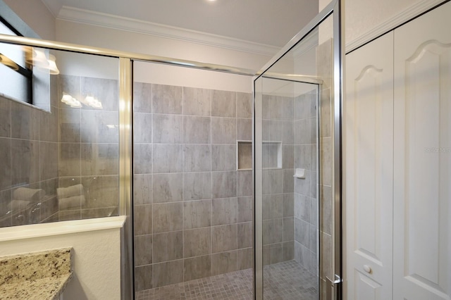 bathroom featuring crown molding, vanity, and a shower with shower door