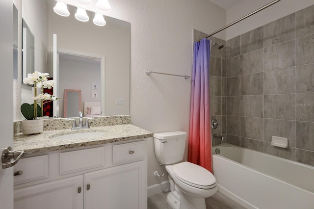 full bathroom with hardwood / wood-style flooring, vanity, shower / tub combo, and toilet