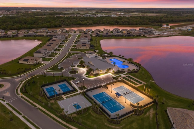 aerial view at dusk with a water view