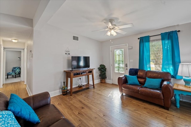 living room with ceiling fan and light wood-type flooring