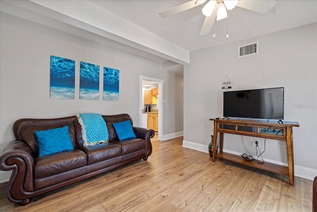 living room with light wood-type flooring and ceiling fan