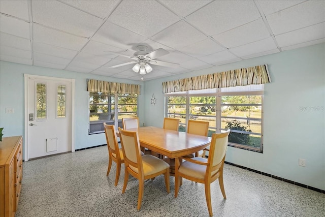 dining room featuring ceiling fan and a drop ceiling