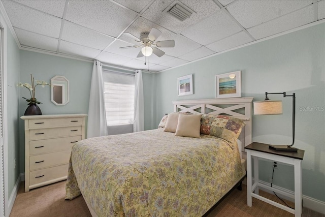 bedroom featuring a paneled ceiling, ceiling fan, and dark carpet