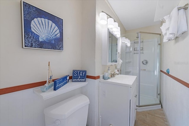 bathroom featuring tile patterned flooring, toilet, vanity, and walk in shower