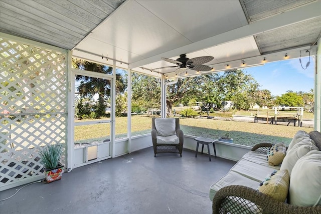 sunroom / solarium featuring ceiling fan