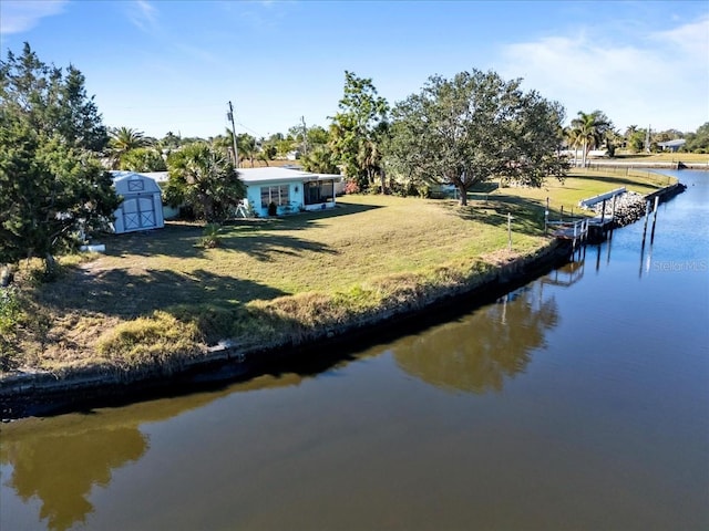 exterior space featuring a yard and a water view